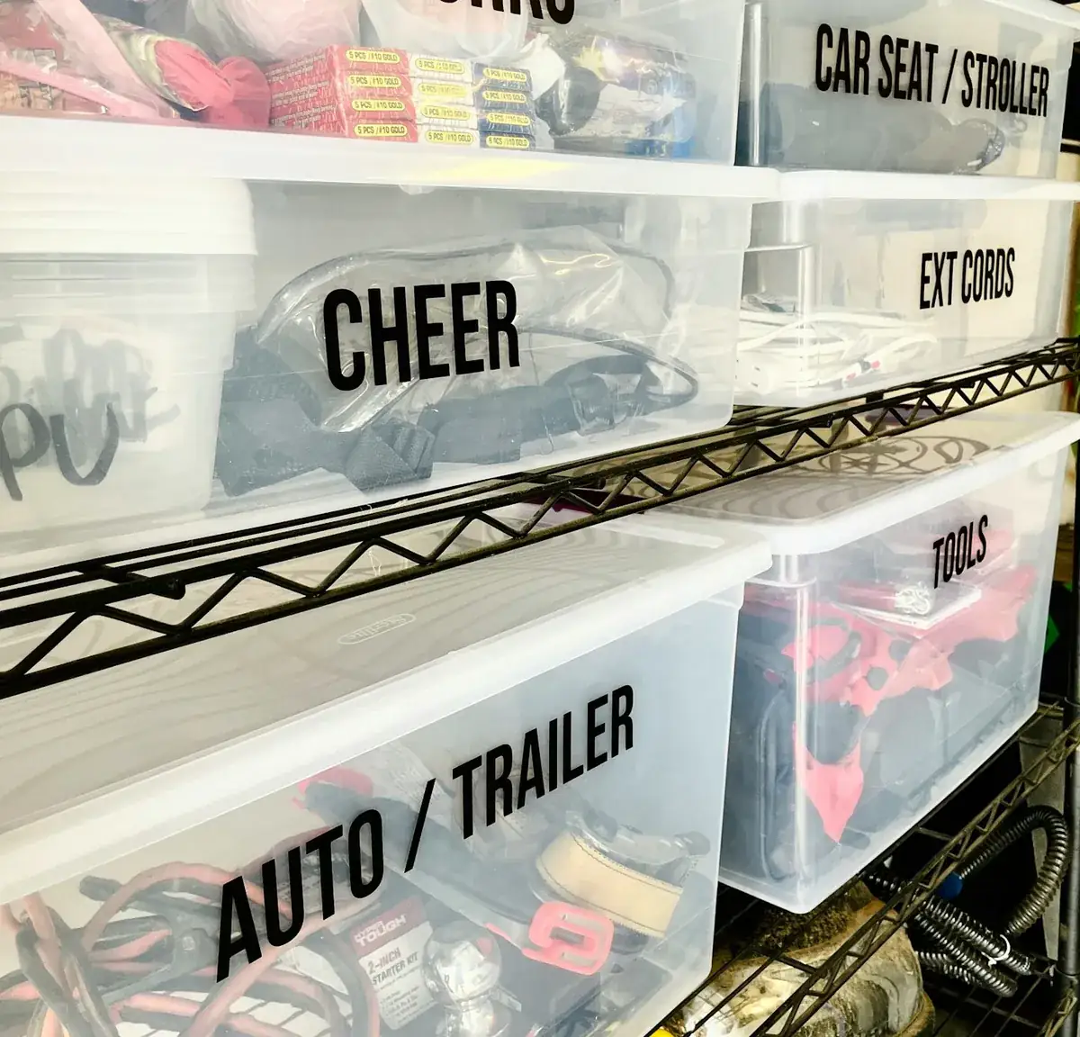 Labelled storage totes on open wire shelving in a garage before custom cabinets are fitted in Huntington Beach CA