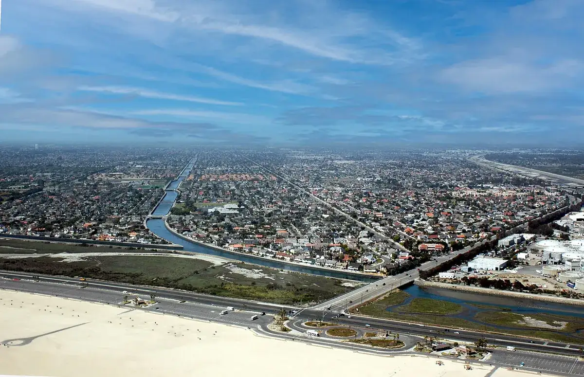 Aerial view of Huntington Beach CA tract housing, the flood control channel and Pacific Coast Highway