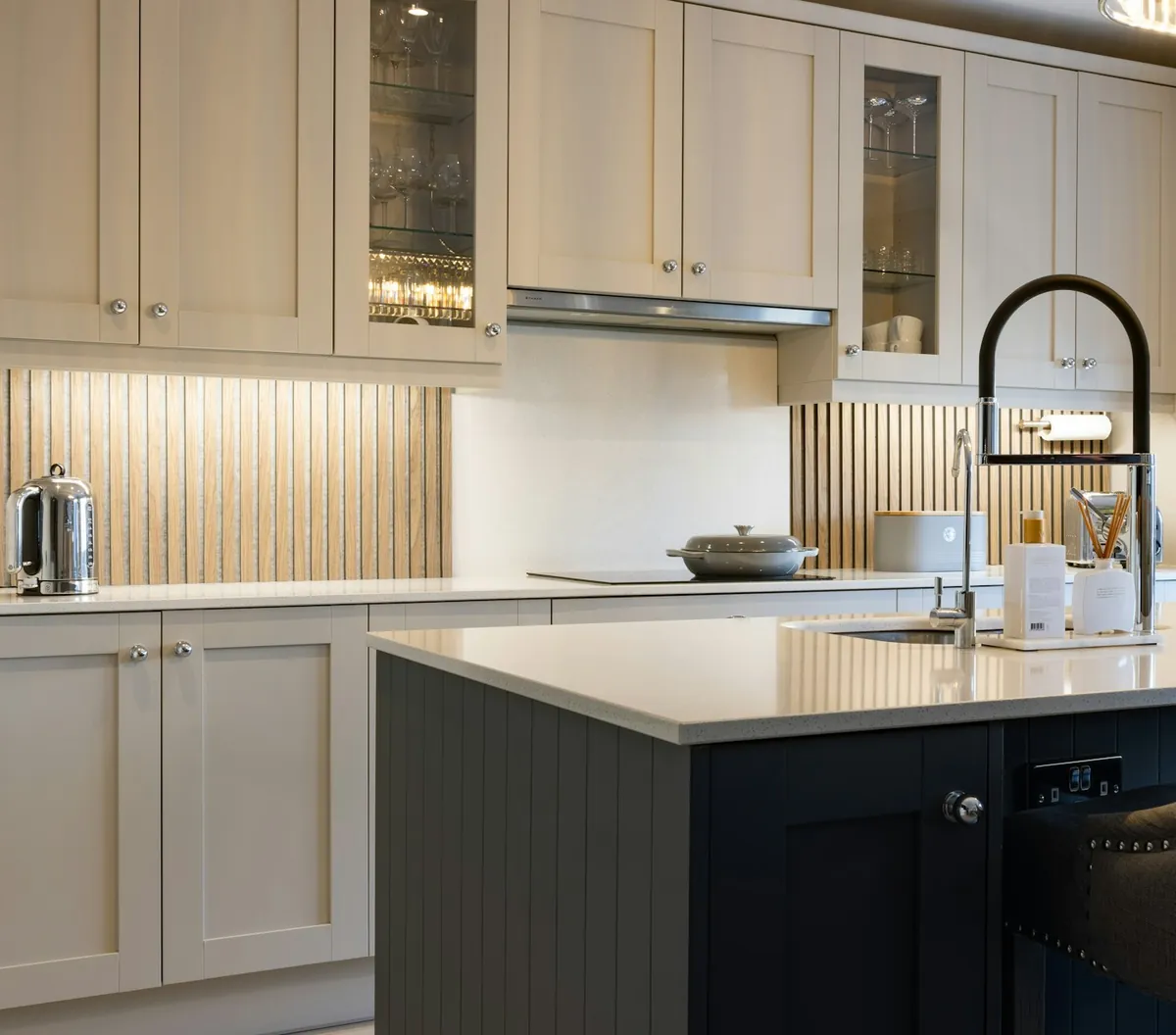 Painted shaker cabinets with glass display fronts and a contrasting island, a common specification in Costa Mesa CA
