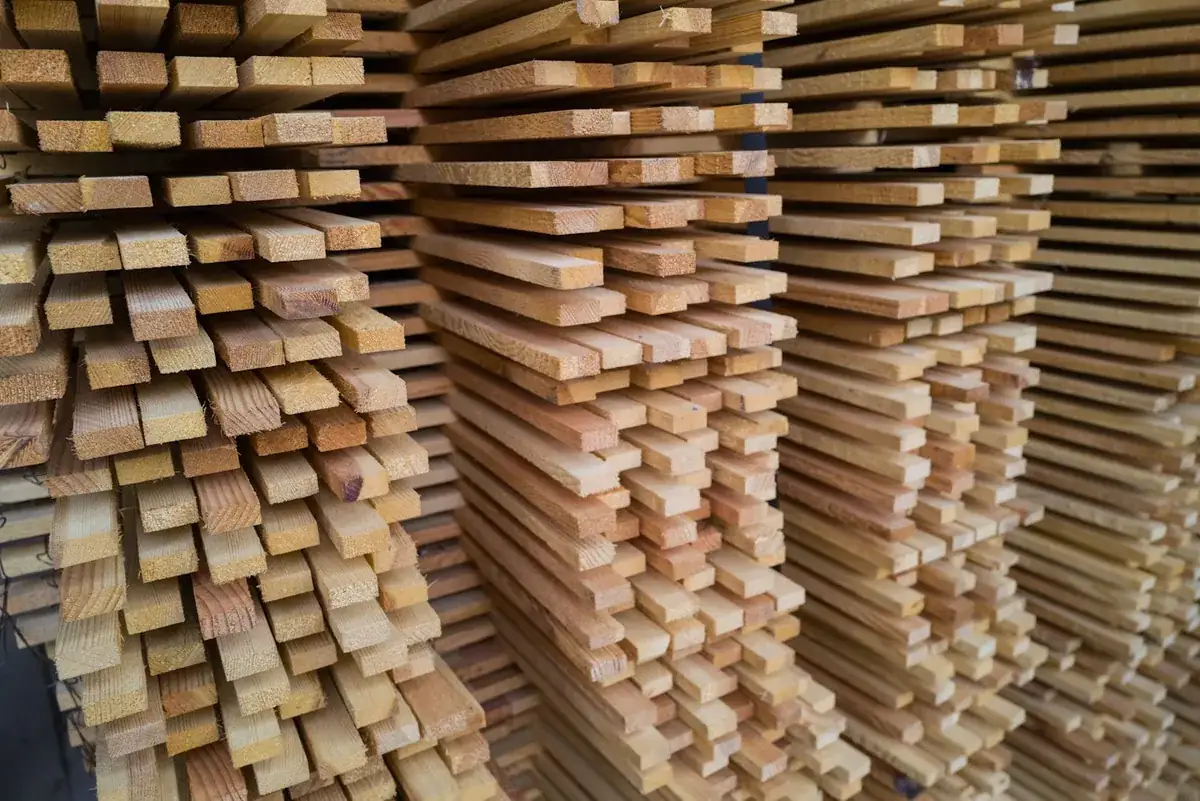 Stickered stacks of sawn timber in a warehouse awaiting machining into cabinet components