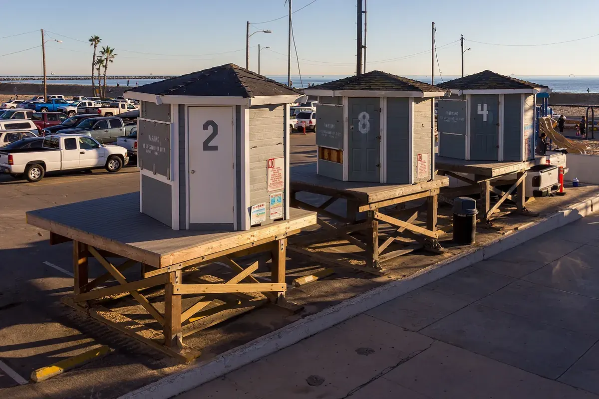 Timber lifeguard huts in the beachfront parking lot at Seal Beach CA in evening light